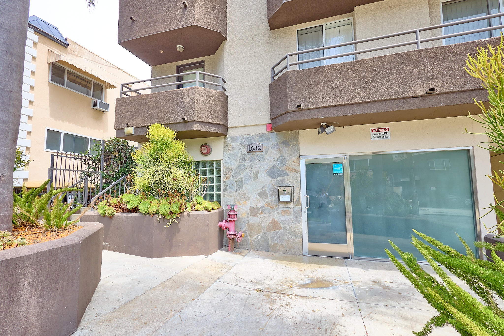 A building with a balcony and a glass door.